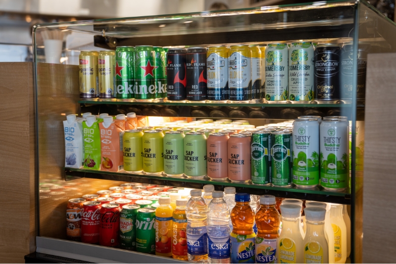 A variety of beverages in a standup glass cooler