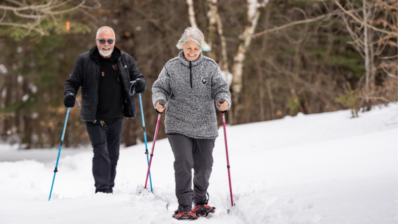 Older man and woman snowshoeing