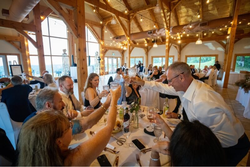 People around a table set for a wedding